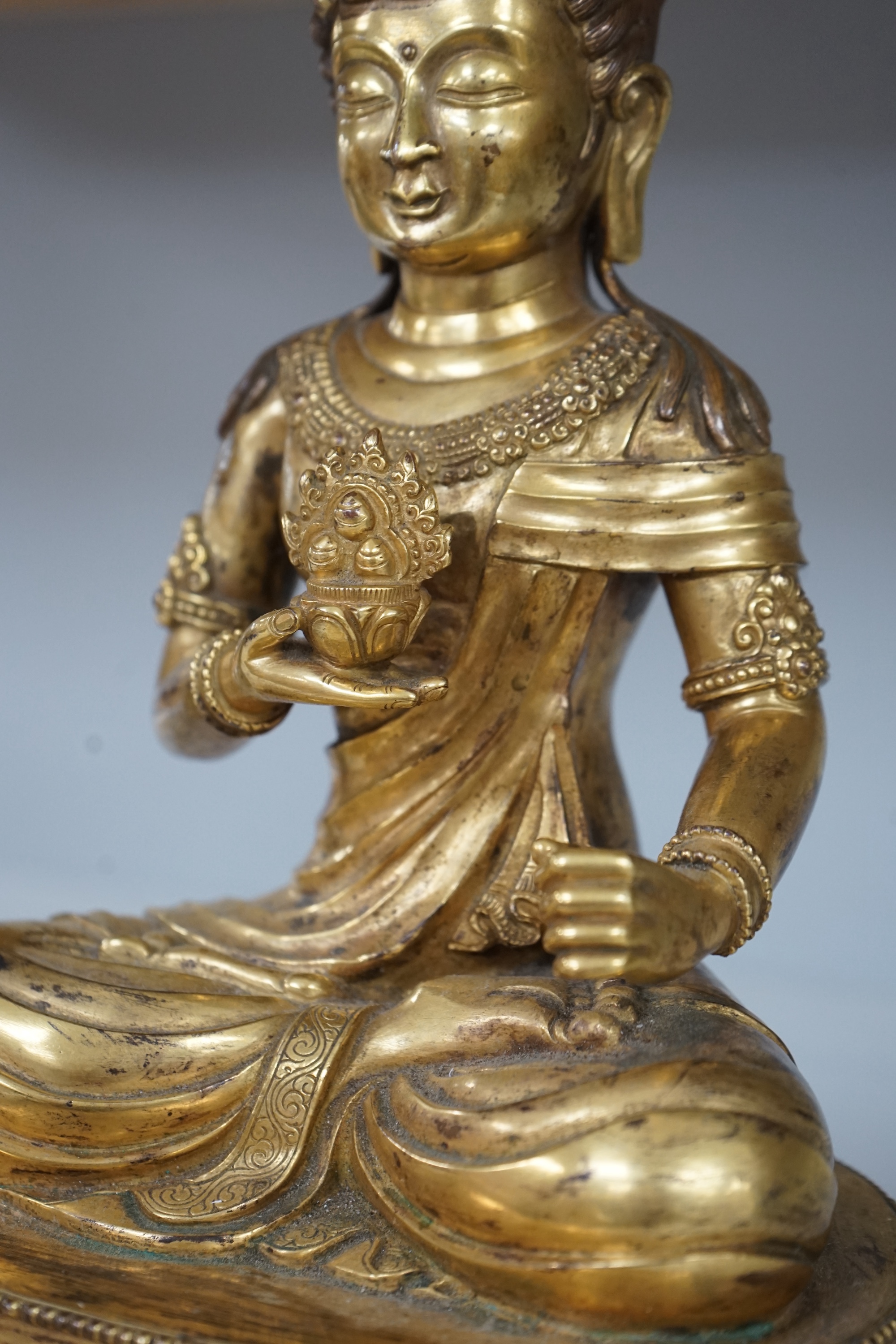 Tibetan School, 20th century gilt bronze figure of a seated deity, 31cm high. Condition - good